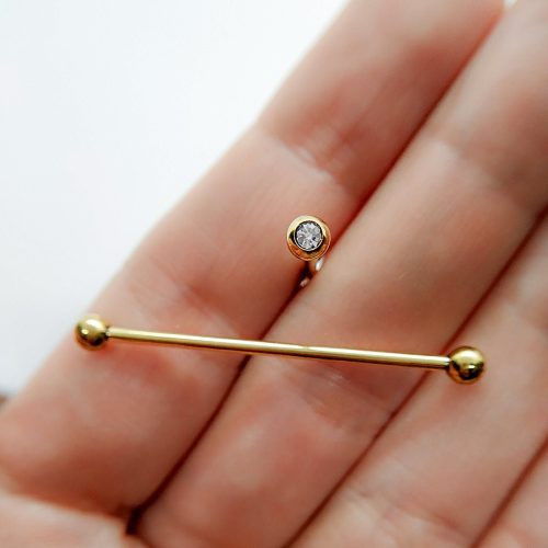 Industrial barbell with CZ screw balls in gold color surgical steel