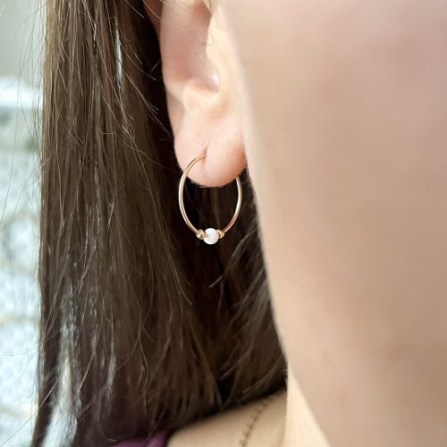 Slim opal hoop earrings in 14k gold filled with a pink opal bead