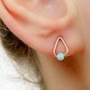 Opal teardrop stud earrings in {material} with a {opal color} opal bead